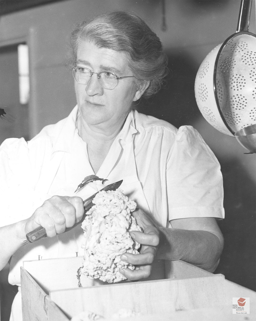 Gladys Mulkey of Philomath cutting cauliflower in the Camp Adair kitchen