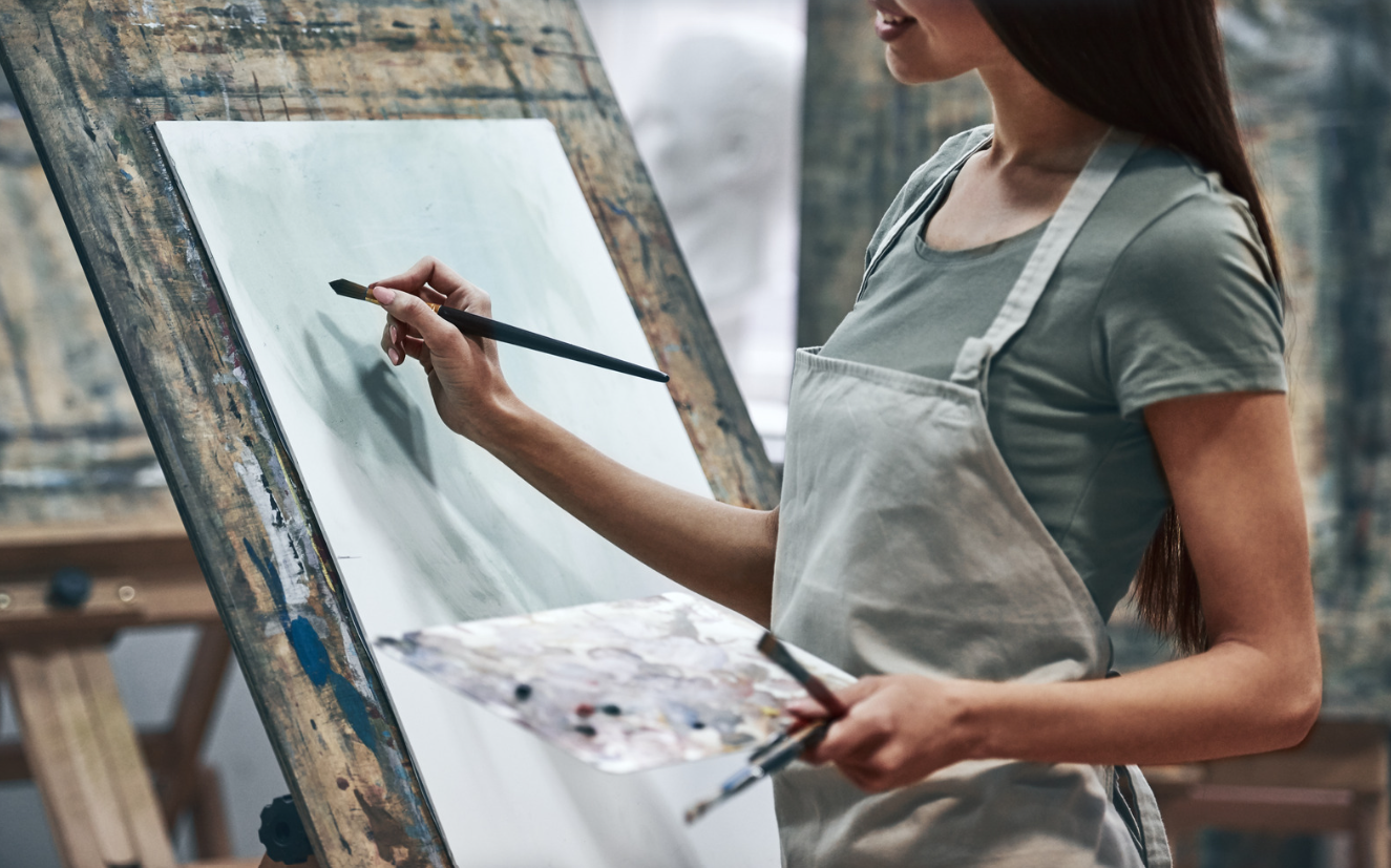 image of artist painting on canvas